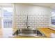 The kitchen features stainless-steel sink with subway tile backsplash and butcher block countertops at 1007 11Th St, St Cloud, FL 34769