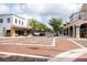 Charming street view featuring brick-paved roads, storefronts, and mature trees at 1007 11Th St, St Cloud, FL 34769