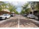 Straight street view featuring brick-paved roads, stores, trees, and parked cars at 1007 11Th St, St Cloud, FL 34769