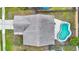 Aerial view of a home featuring a backyard swimming pool, patio, fenced yard, and concrete driveway at 1050 Dees Dr, Oviedo, FL 32765
