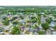 An aerial view showing a community dotted with homes, lush green trees, and a serene lake in the distance at 1050 Dees Dr, Oviedo, FL 32765