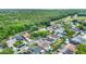 An aerial view featuring a neighborhood with lush greenery and tree coverage and a river in the background at 1050 Dees Dr, Oviedo, FL 32765