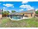 Backyard with inviting pool, patio set, lush grass and mature landscaping at 1050 Dees Dr, Oviedo, FL 32765