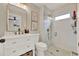 Updated bathroom with a glass enclosed shower, modern fixtures, and white vanity at 1050 Dees Dr, Oviedo, FL 32765