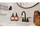 A bathroom sink area is showcased with stylish decor, warm lighting, and a modern sink with a sleek bronze faucet at 1050 Dees Dr, Oviedo, FL 32765