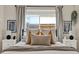 Comfortable bedroom with neutral decor, layered pillows, and a cozy throw for a relaxing retreat at 1050 Dees Dr, Oviedo, FL 32765