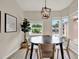 Bright dining room with modern decor, stylish accents, and large windows offering neighborhood views at 1050 Dees Dr, Oviedo, FL 32765