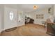 Inviting entryway featuring wood-look floors, home office, and bright natural light at 1050 Dees Dr, Oviedo, FL 32765