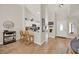 Open-concept entryway with wood-look floors leading to the kitchen and a cozy breakfast bar at 1050 Dees Dr, Oviedo, FL 32765