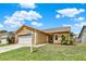Well-maintained home featuring an attached garage, landscaping, and inviting curb appeal at 1050 Dees Dr, Oviedo, FL 32765