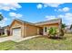 Charming one-story home with a two-car garage, well-maintained lawn, and beautiful landscaping at 1050 Dees Dr, Oviedo, FL 32765