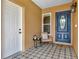 The front porch features decorative tile flooring and a stylish blue front door at 1050 Dees Dr, Oviedo, FL 32765