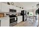 Modern kitchen featuring stainless steel appliances, white cabinets, and stylish countertops for a sleek and functional space at 1050 Dees Dr, Oviedo, FL 32765
