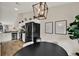 Charming kitchen and dining area featuring stainless steel appliances and an elegant light fixture above the dining table at 1050 Dees Dr, Oviedo, FL 32765