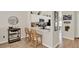 Modern kitchen features white cabinetry, stainless steel appliances, and a breakfast bar with seating at 1050 Dees Dr, Oviedo, FL 32765