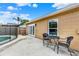 Patio with table and chairs, French doors, and view of the pool with safety fence at 1050 Dees Dr, Oviedo, FL 32765