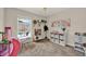 Playroom with natural light, a play kitchen, shelving with toys, and a view of the pool creating an inspiring place at 1050 Dees Dr, Oviedo, FL 32765