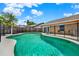 Sparkling pool with safety fence, sunny patio and lush backyard landscaping at 1050 Dees Dr, Oviedo, FL 32765
