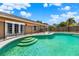 Inviting pool with safety fence, sunny patio and serene backyard views at 1050 Dees Dr, Oviedo, FL 32765