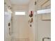 Modern bathroom featuring a sleek shower stall with glass door, white tile, bronze fixtures, and a built-in niche at 1050 Dees Dr, Oviedo, FL 32765