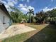 Spacious backyard featuring a concrete patio and mature trees providing ample shade at 1098 Leeway Ct, Orlando, FL 32810