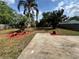Backyard featuring a concrete patio and lush tropical landscaping at 1098 Leeway Ct, Orlando, FL 32810