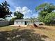 Back exterior view with concrete patio and lush tropical landscaping at 1098 Leeway Ct, Orlando, FL 32810