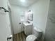 Updated bathroom with white vanity, modern fixtures, and wood look flooring at 1098 Leeway Ct, Orlando, FL 32810