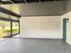 Open carport showing painted floors and walls, along with an exterior door at 1098 Leeway Ct, Orlando, FL 32810