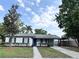 Charming single-story home featuring black shutters, fresh landscaping, and a convenient covered carport at 1098 Leeway Ct, Orlando, FL 32810