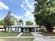 Charming single-story home featuring black shutters, fresh landscaping, and a convenient covered carport at 1098 Leeway Ct, Orlando, FL 32810