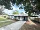 Charming single-story home with black shutters and a convenient covered carport and long driveway at 1098 Leeway Ct, Orlando, FL 32810