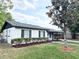 Charming single-story home with black shutters and a well-maintained landscaped yard with lush green grass at 1098 Leeway Ct, Orlando, FL 32810