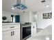 Modern kitchen featuring stainless steel stove and range hood and an island with stone countertop at 1098 Leeway Ct, Orlando, FL 32810