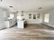 Renovated kitchen with stainless appliances, shaker cabinets, and an island with seating at 1098 Leeway Ct, Orlando, FL 32810