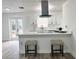 Bright and modern kitchen with a large island, pendant lighting, and stainless steel range hood at 1098 Leeway Ct, Orlando, FL 32810