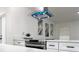 Kitchen with stainless steel stove and hood and white counter tops and cabinets at 1098 Leeway Ct, Orlando, FL 32810
