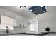 Bright, modern kitchen showcasing white cabinets, stone countertops, and stainless steel appliances at 1098 Leeway Ct, Orlando, FL 32810