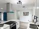 Modern kitchen with a large island, stainless steel appliances, and white cabinets at 1098 Leeway Ct, Orlando, FL 32810
