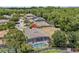 Overhead shot showcases the property's location surrounded by lush greenery and neighboring houses at 1103 Cypress Pointe Blvd, Davenport, FL 33896
