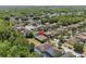 Aerial view of a home nestled in a neighborhood, with lush greenery and nearby houses at 1103 Cypress Pointe Blvd, Davenport, FL 33896