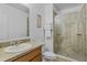 Modern bathroom featuring a tiled shower, large mirror, and single vanity at 1103 Cypress Pointe Blvd, Davenport, FL 33896