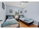 Cozy bedroom featuring two twin beds with decor and hardwood floors, offering a comfortable space at 1103 Cypress Pointe Blvd, Davenport, FL 33896