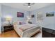 Light, bright bedroom featuring hardwood floors and modern furnishings, perfect for relaxation at 1103 Cypress Pointe Blvd, Davenport, FL 33896
