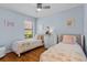 Twin bedroom decorated with light blue walls, hardwood floors and light decor at 1103 Cypress Pointe Blvd, Davenport, FL 33896