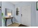 Bright entryway with a modern console table and stylish mirror accent at 1103 Cypress Pointe Blvd, Davenport, FL 33896