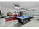 Spacious garage converted into a game room with a pool table and sitting area at 1103 Cypress Pointe Blvd, Davenport, FL 33896
