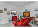 Garage sitting area with a television and red cushioned chairs at 1103 Cypress Pointe Blvd, Davenport, FL 33896