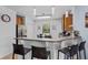 Well-lit kitchen featuring granite countertops, wooden cabinets, and stainless-steel appliances at 1103 Cypress Pointe Blvd, Davenport, FL 33896