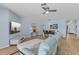 Spacious living room with contemporary decor, tile flooring, and ample seating at 1103 Cypress Pointe Blvd, Davenport, FL 33896